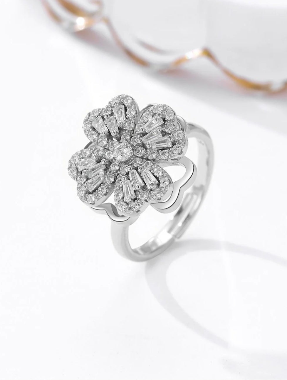 Flower motif with Petals rotating around a Central Adjustable Silver Ring